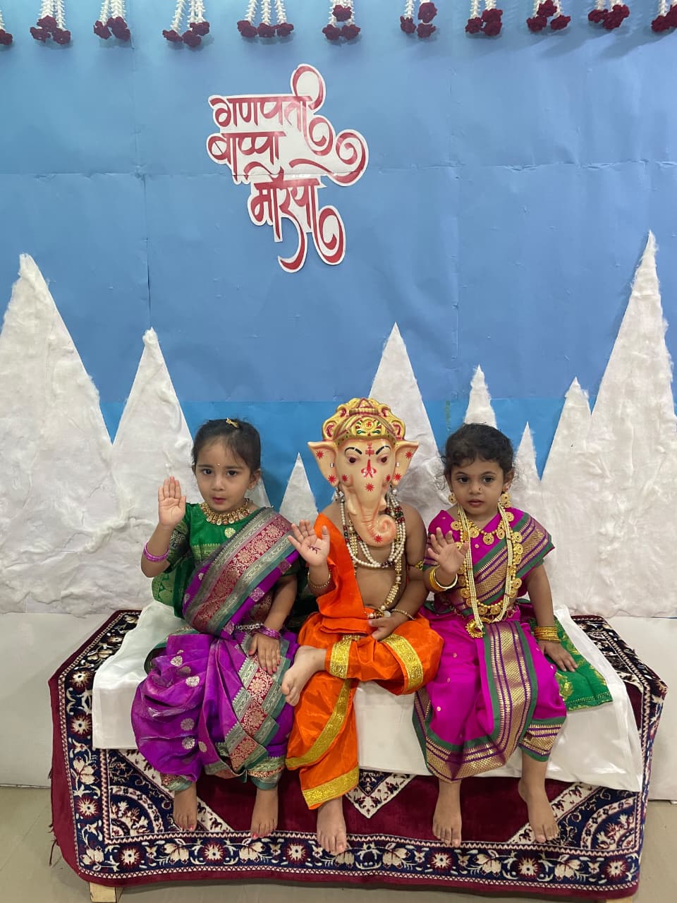Children in traditional attire with Ganpati idol for Ganesh Chaturthi