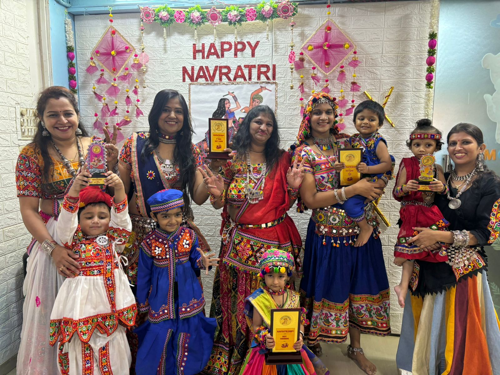 Children and teachers in traditional dress celebrating Navratri