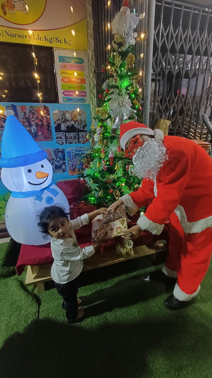 Santa Claus handing a gift to a child